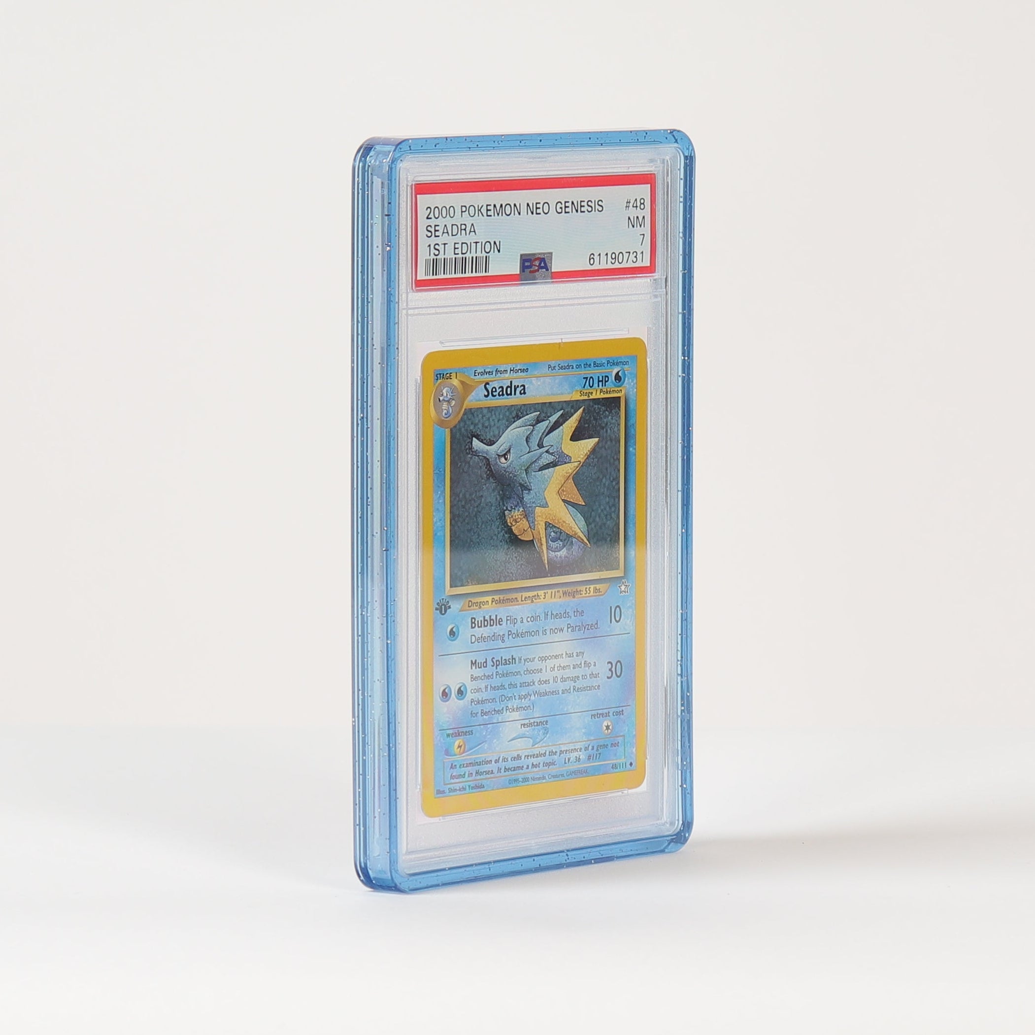 A graded Pokémon TCG card in a clear PSA-style plastic slab, standing upright on a white studio surface against a white background.