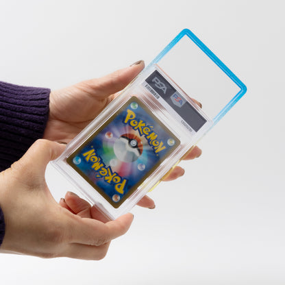 Hand holding a Pokémon trading card in a protective case with a PSA grading label.
