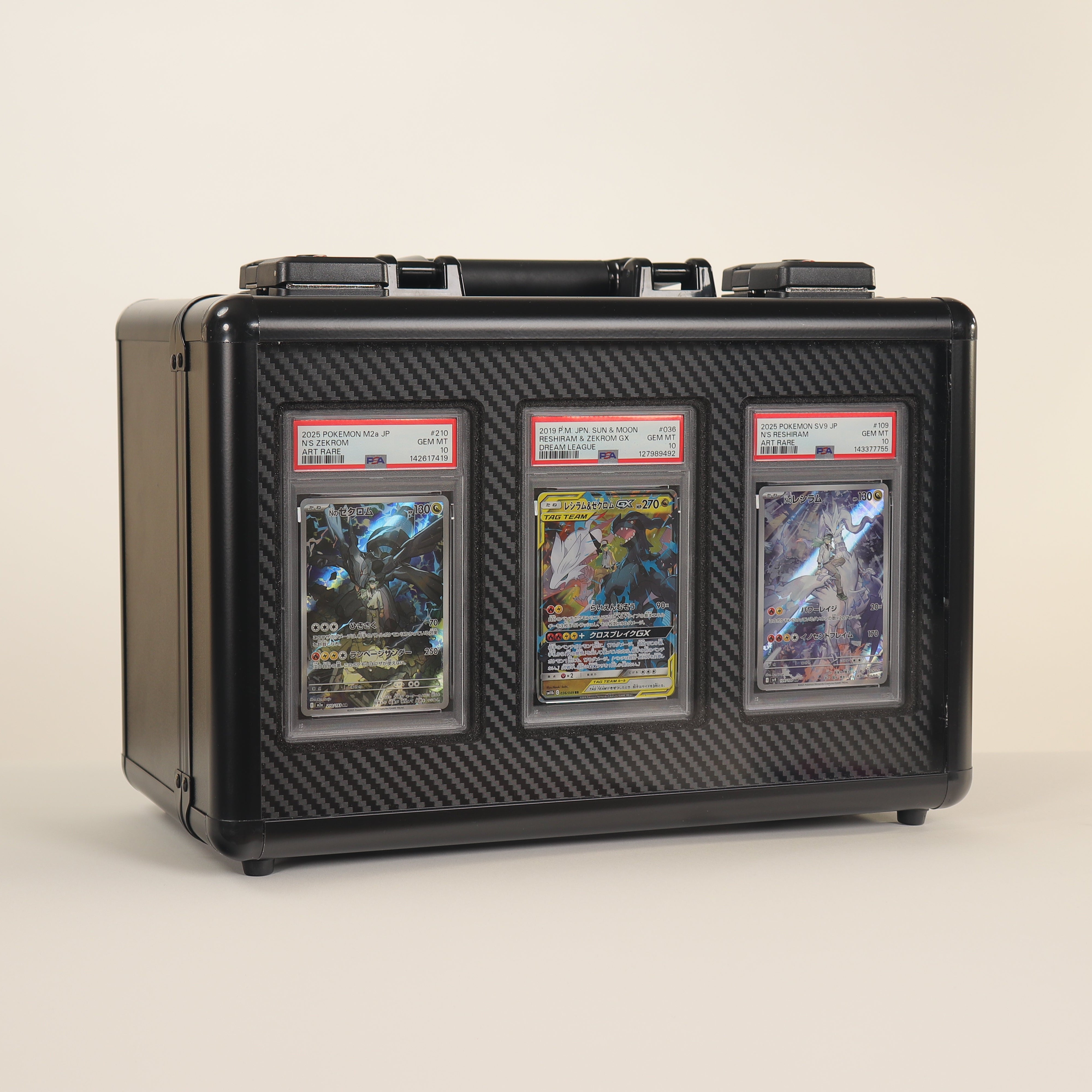 Black protective case with three trading cards on a beige background